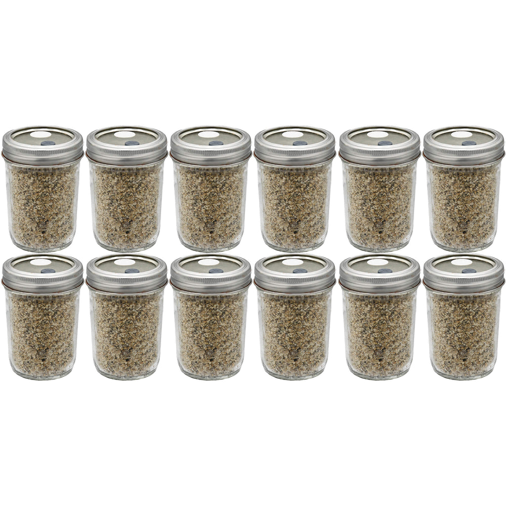 Twelve half-pint jars filled with a sterilized mix of brown rice flour and vermiculite substrate, arranged in a grid. The jars feature self-healing injection ports on the lids, ideal for easy inoculation and efficient mushroom cultivation.